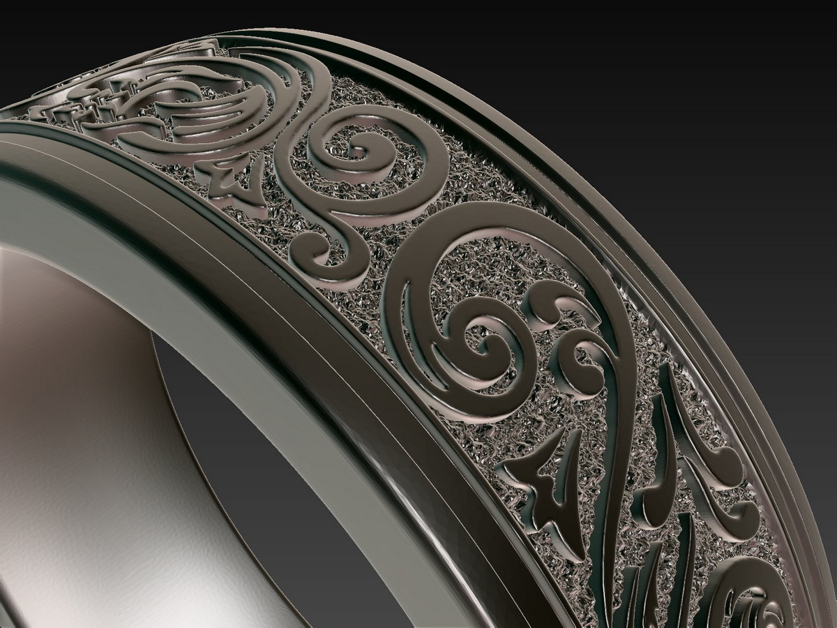 Close-up of the ornamental ring showing the raised sculpted relief against a rough textured surface, revealing the depth and contrast of the design.